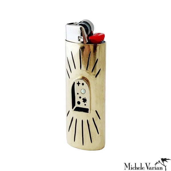 Gold lighter with arched window design on a white background