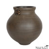 Brown ceramic vase with a knot detail on a white background