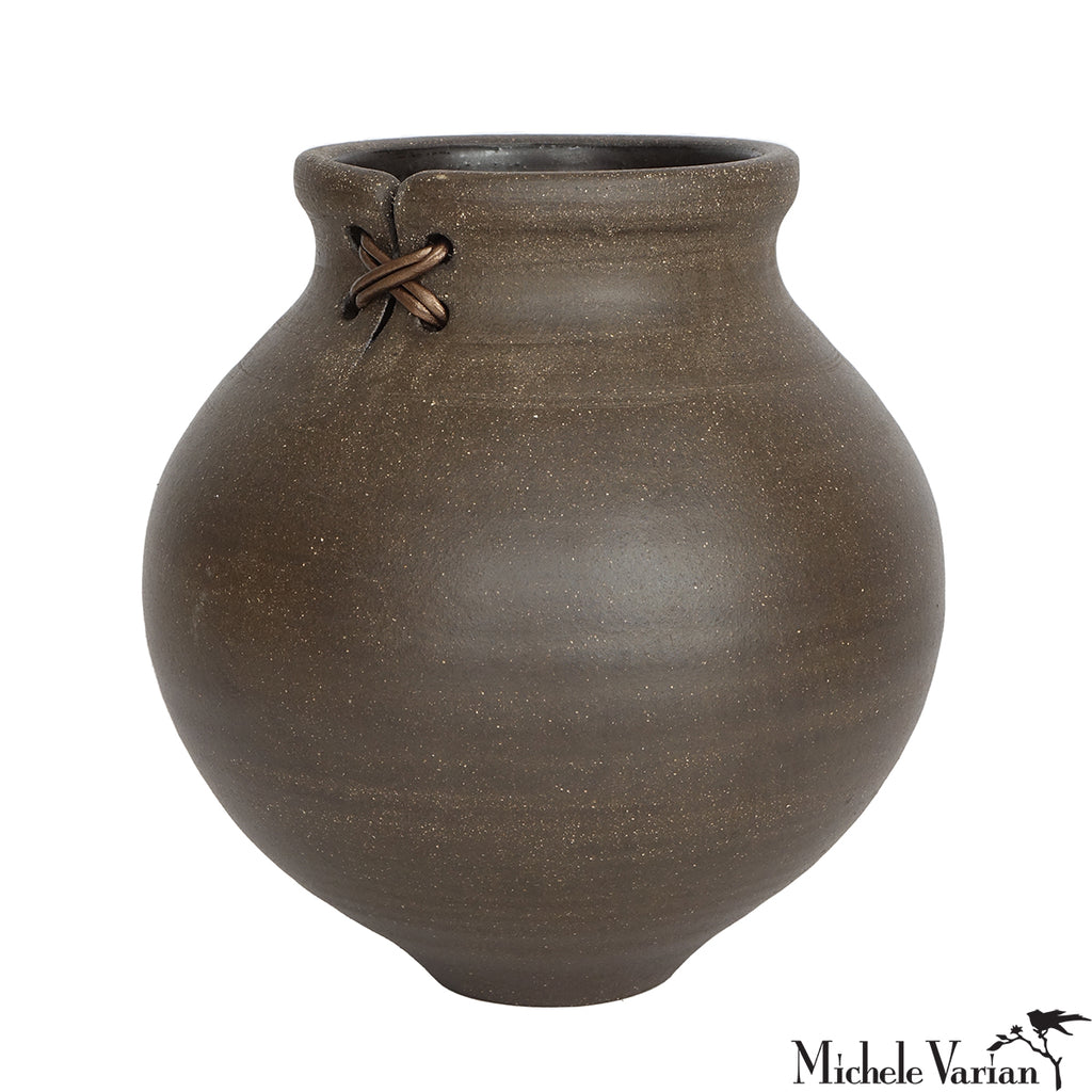 Brown ceramic vase with a knot detail on a white background
