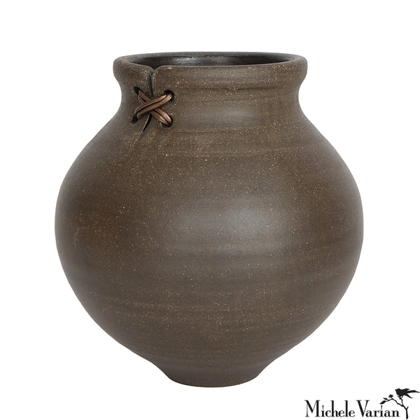 Brown ceramic vase with a knot detail on a white background