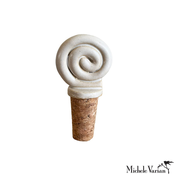 Decorative cork bottle stopper with swirl design on a white background