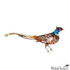 Colorful bird-shaped brooch on a white background