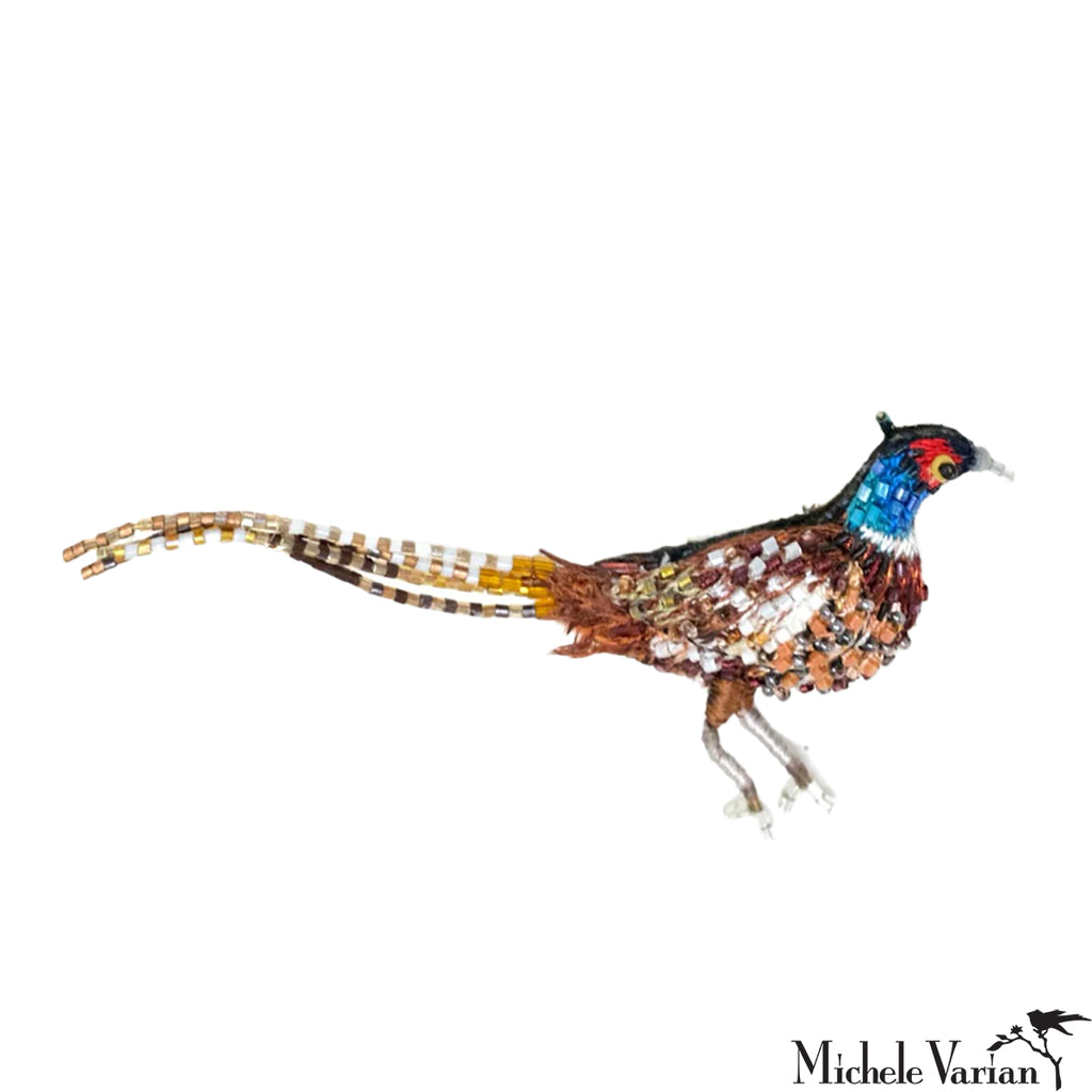 Colorful bird-shaped brooch on a white background