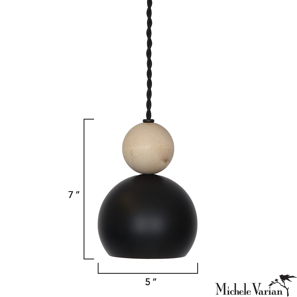 A pendant light with a black and beige spherical design on a white background, featuring measurements, designed by Michele Varian.