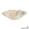 Beige ceramic dish with wavy edge on a white background