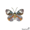 Colorful beaded butterfly pin on a white background