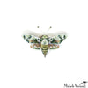 Decorative butterfly brooch with intricate design on a white background