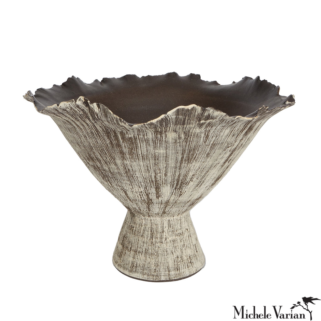 Decorative vase with textured surface and wavy rim on a white background