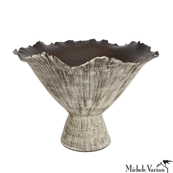 Decorative vase with textured surface and wavy rim on a white background