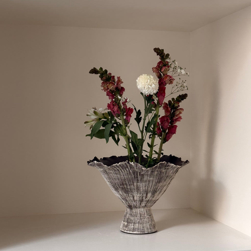 Decorative vase with flowers on a neutral background