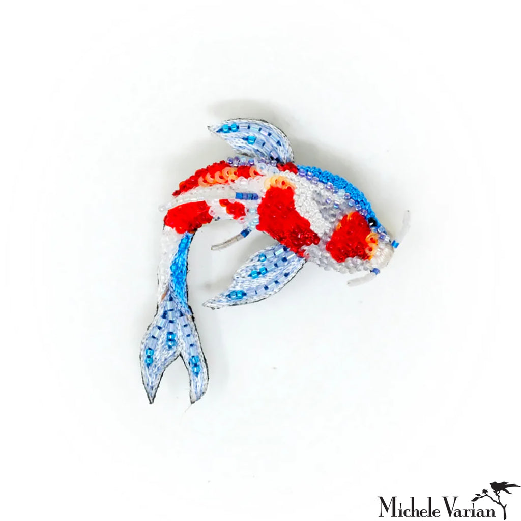 Colorful fish-shaped object with red, blue, and white colors on a white background