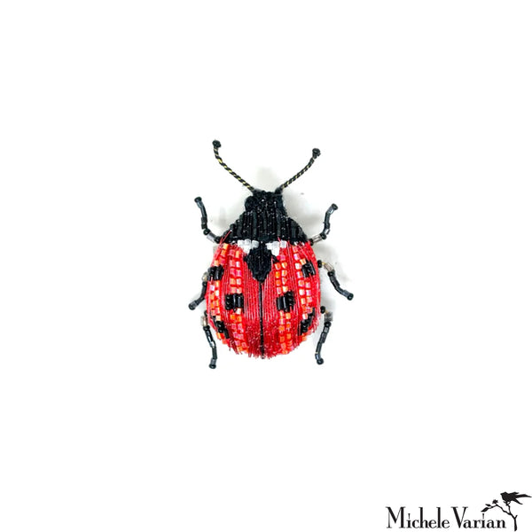 Beaded ladybug pin on a white background