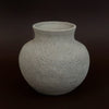 Textured ceramic vase on a dark background