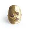 Gold ring with embedded stones on a white background