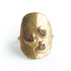 Gold ring with embedded stones on a white background