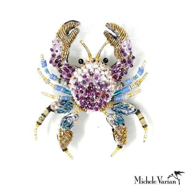 Colorful beaded crab-shaped brooch with on a white background