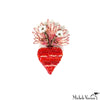 Decorative brooch with red heart design and floral top on a white background