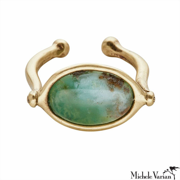 Gold ring with a smooth green oval stone on a white background.