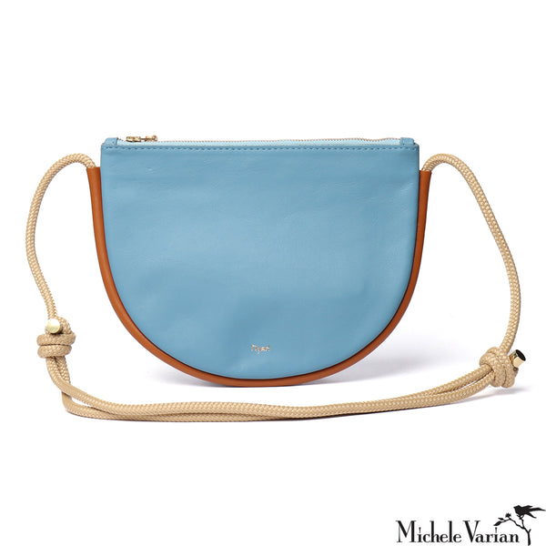 Blue handbag with a beige strap on a white background