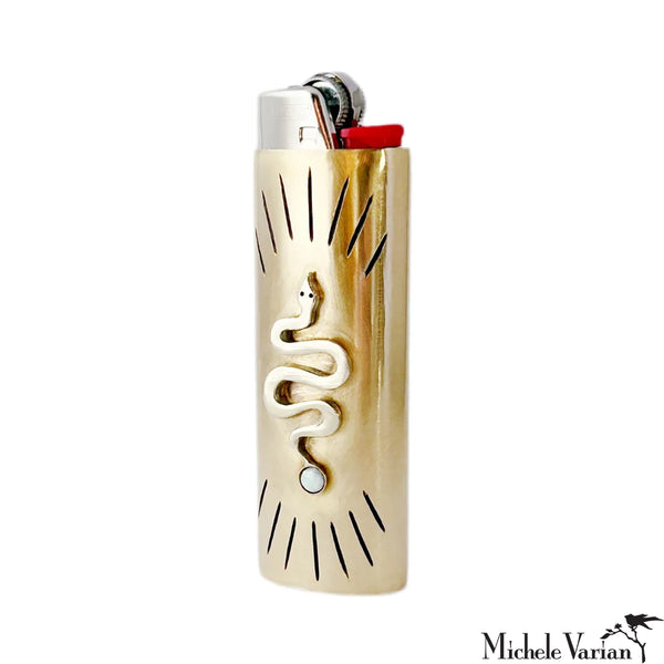 Gold lighter with snake design on a white background