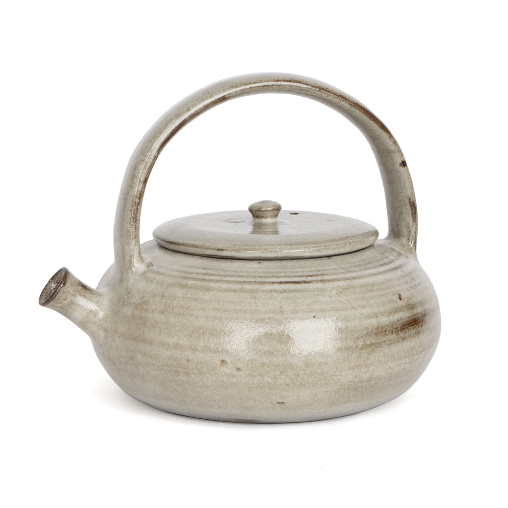 Ceramic teapot with a lid on a white background