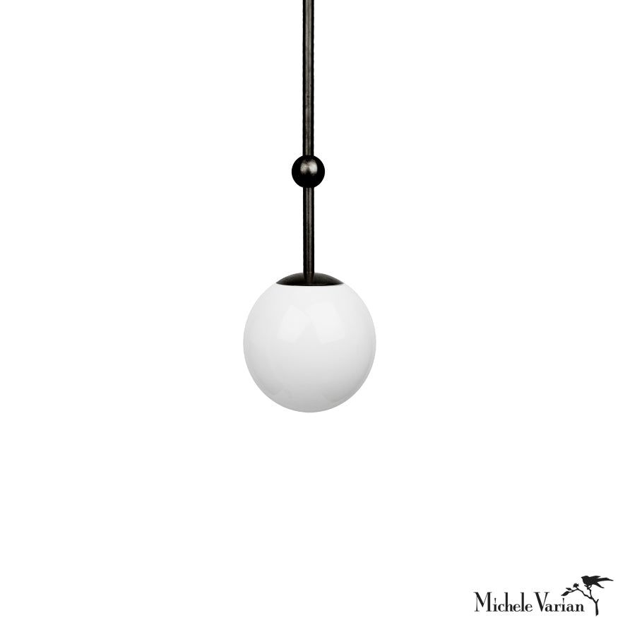 A modern 6 inch black pendant light with a white globe, designed by Michele Varian.